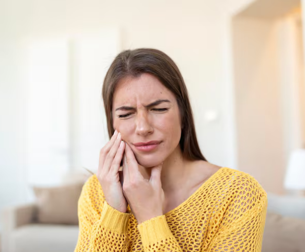 Person experiencing worsening wisdom tooth pain at the back of the jaw